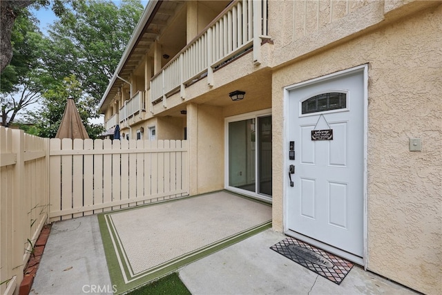 8121 Canby Ave Unit 4, Reseda, CA 91335 - property entrance with stucco siding, a balcony, and a patio area