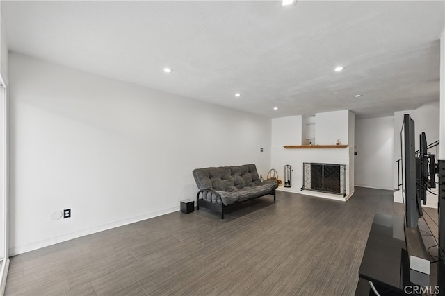 8121 Canby Ave Unit 4, Reseda, CA 91335 - sitting room featuring dark wood-style floors, recessed lighting, a fireplace with raised hearth, and baseboards