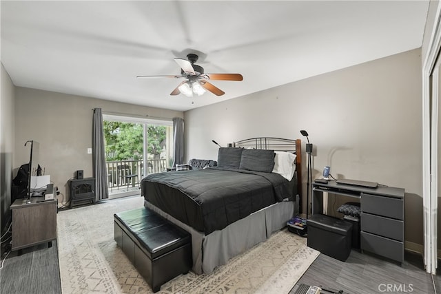 8121 Canby Ave Unit 4, Reseda, CA 91335 - bedroom with access to outside, ceiling fan, and a wood stove