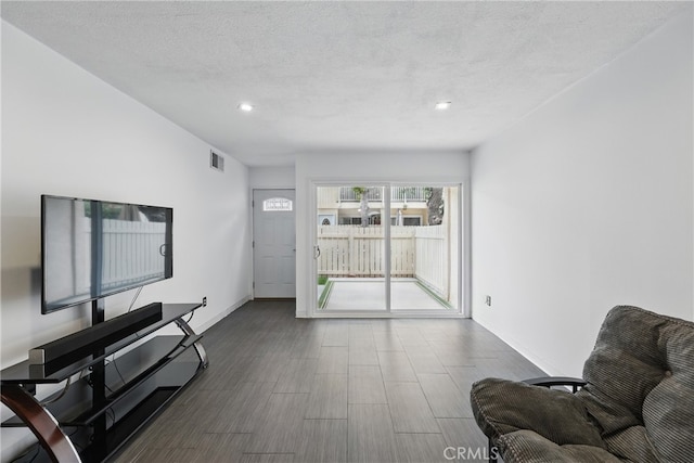 8121 Canby Ave Unit 4, Reseda, CA 91335 - living area featuring baseboards, a textured ceiling, wood finished floors, and recessed lighting