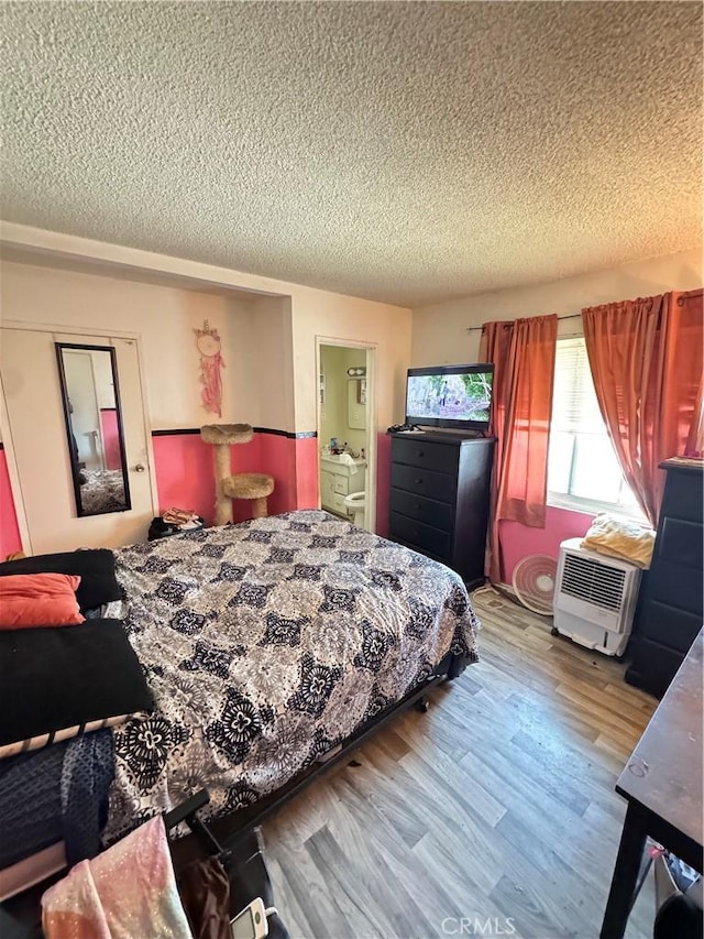 45529 Sancroft Ave, Lancaster, CA 93535 - bedroom featuring a textured ceiling and wood finished floors