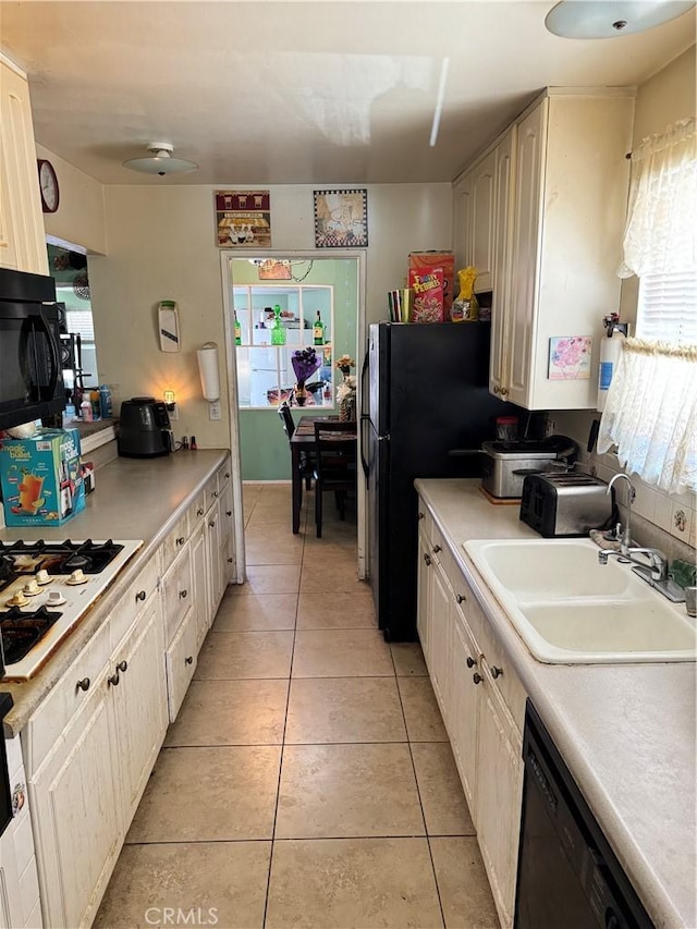 45529 Sancroft Ave, Lancaster, CA 93535 - kitchen featuring black appliances, a sink, light countertops, and light tile patterned flooring