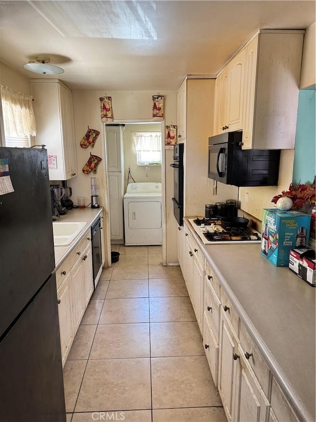 45529 Sancroft Ave, Lancaster, CA 93535 - kitchen featuring washer / dryer, black appliances, light tile patterned floors, light countertops, and a sink