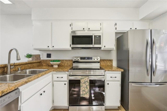 25447 Pine Creek Ln, Wilmington, CA 90744 - kitchen with appliances with stainless steel finishes, a sink, and white cabinetry