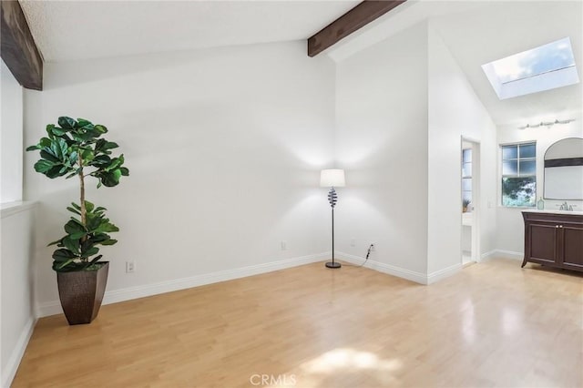 25447 Pine Creek Ln, Wilmington, CA 90744 - interior space with a skylight, light wood-style flooring, baseboards, and a sink