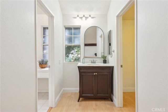 25447 Pine Creek Ln, Wilmington, CA 90744 - bathroom with vanity, wood finished floors, and baseboards