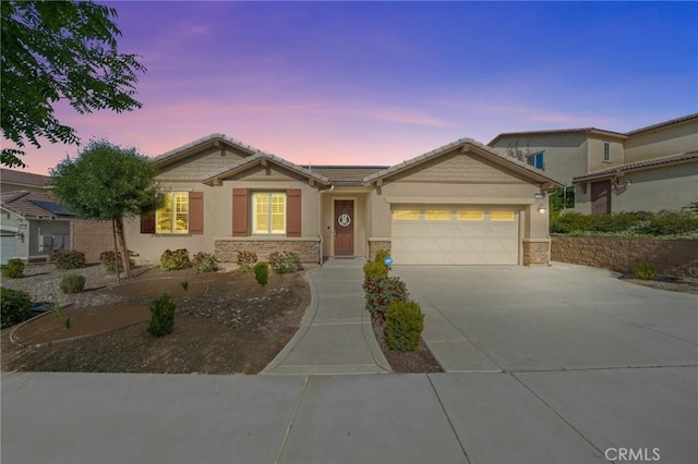 11066 Guffey Ranch Way, Corona, CA 92883 - view of front of home with driveway, a garage, stone siding, and stucco siding