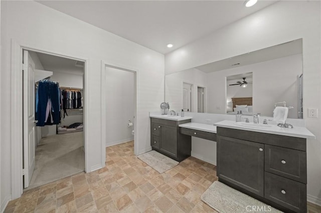 11066 Guffey Ranch Way, Corona, CA 92883 - full bathroom featuring ceiling fan, stone finish floors, toilet, two vanities, and baseboards