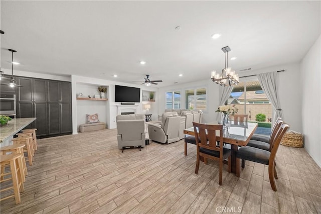 11066 Guffey Ranch Way, Corona, CA 92883 - dining area featuring light wood-style floors, a ceiling fan, recessed lighting, and a chandelier