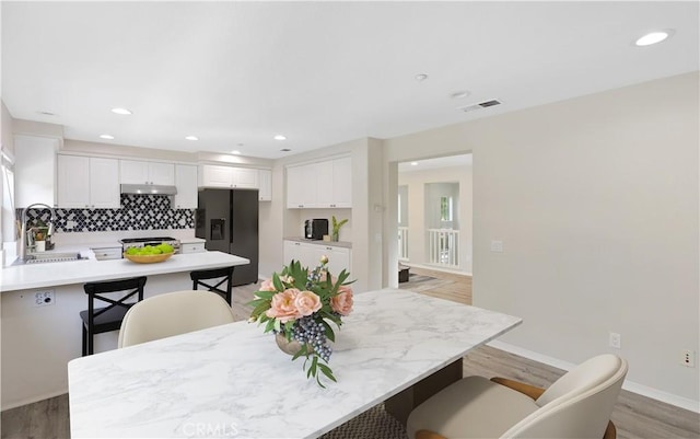 36 Chula Vis Unit 109, Irvine, CA 92602 - dining area with light wood-style floors, recessed lighting, and baseboards