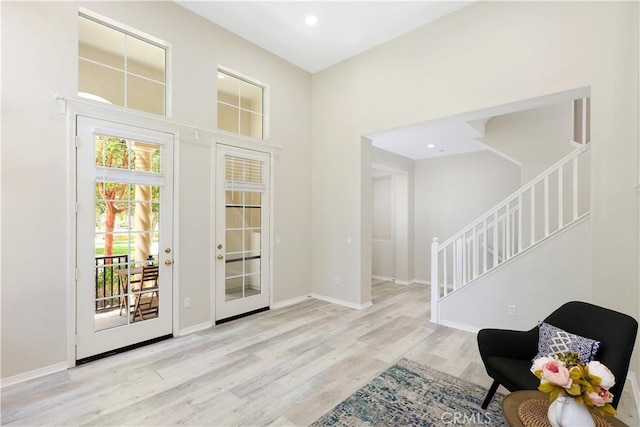 36 Chula Vis Unit 109, Irvine, CA 92602 - foyer with stairs, wood finished floors, baseboards, a high ceiling, and recessed lighting