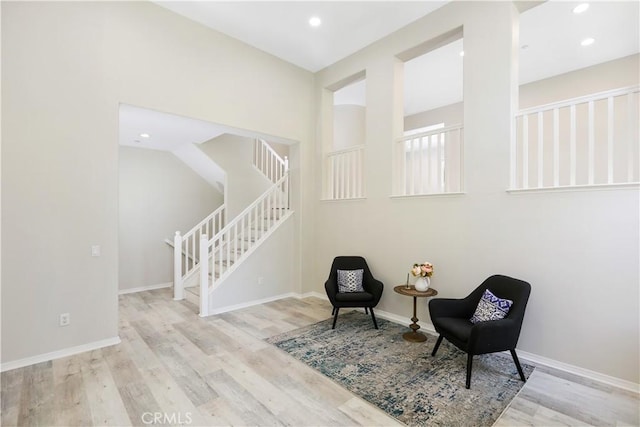 36 Chula Vis Unit 109, Irvine, CA 92602 - sitting room featuring stairway, wood finished floors, recessed lighting, and baseboards