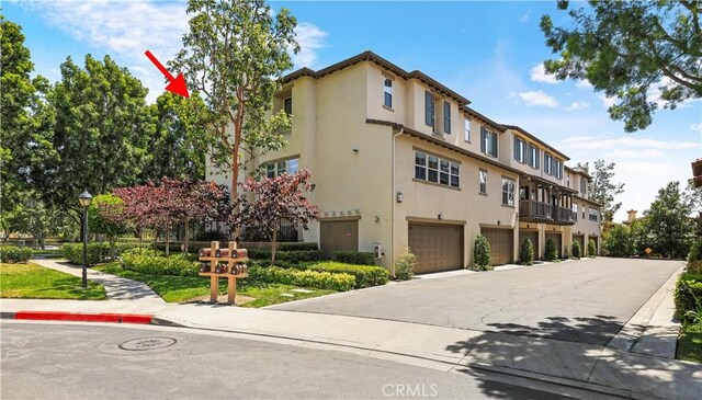 36 Chula Vis Unit 109, Irvine, CA 92602 - view of property featuring a garage and driveway