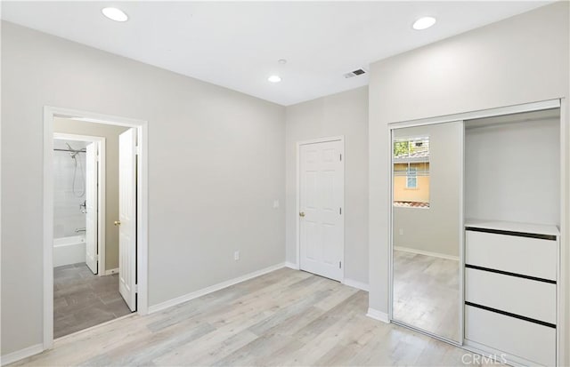 36 Chula Vis Unit 109, Irvine, CA 92602 - unfurnished bedroom featuring light wood-style flooring, recessed lighting, a closet, baseboards, and connected bathroom