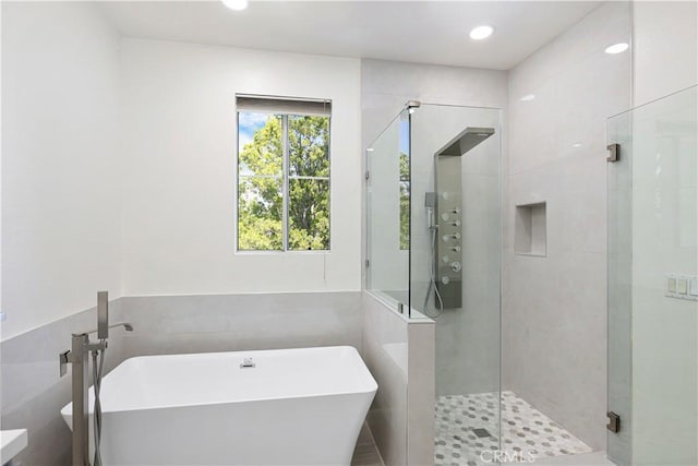 36 Chula Vis Unit 109, Irvine, CA 92602 - full bathroom featuring a shower stall, a freestanding bath, and tile walls