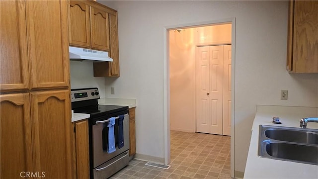 14093 Wingate Cir, Magalia, CA 95954 - kitchen with under cabinet range hood, stainless steel electric range oven, a sink, light countertops, and light floors