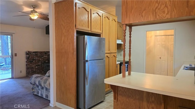 14093 Wingate Cir, Magalia, CA 95954 - kitchen featuring freestanding refrigerator, ceiling fan, under cabinet range hood, light countertops, and a peninsula