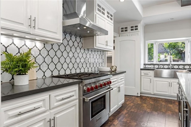 1202 Duke Ln, Walnut, CA 91789 - kitchen with luxury range, wall chimney range hood, white cabinetry, glass insert cabinets, and decorative backsplash
