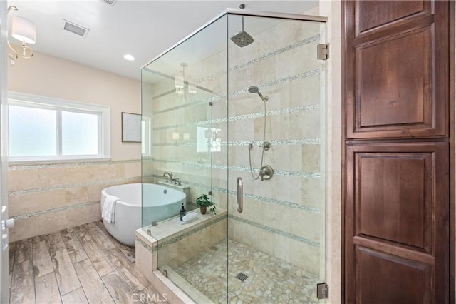 1202 Duke Ln, Walnut, CA 91789 - full bath with tile walls, a freestanding tub, a shower stall, and wood finished floors