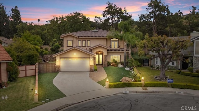 1202 Duke Ln, Walnut, CA 91789 - mediterranean / spanish-style house featuring stucco siding, stone siding, concrete driveway, a garage, and a tile roof