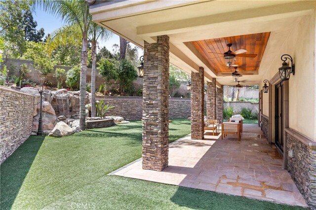 1202 Duke Ln, Walnut, CA 91789 - fenced backyard featuring a ceiling fan and a patio area