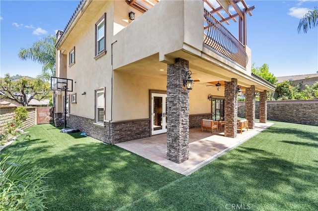 1202 Duke Ln, Walnut, CA 91789 - rear view of house featuring a balcony, stucco siding, stone siding, a ceiling fan, and a patio
