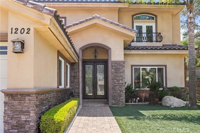1202 Duke Ln, Walnut, CA 91789 - doorway to property featuring french doors, a balcony, stucco siding, stone siding, and a yard