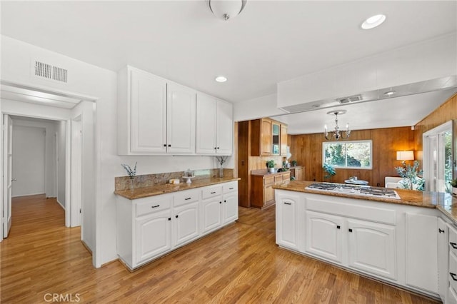 1424 E Vine Ave, West Covina, CA 91791 - kitchen with gas cooktop, a chandelier, white cabinets, light wood finished floors, and recessed lighting