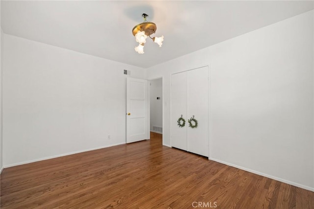1424 E Vine Ave, West Covina, CA 91791 - empty room with a chandelier, wood finished floors, and baseboards