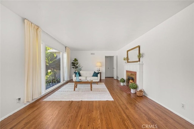 1424 E Vine Ave, West Covina, CA 91791 - living room with wood finished floors, a glass covered fireplace, and baseboards