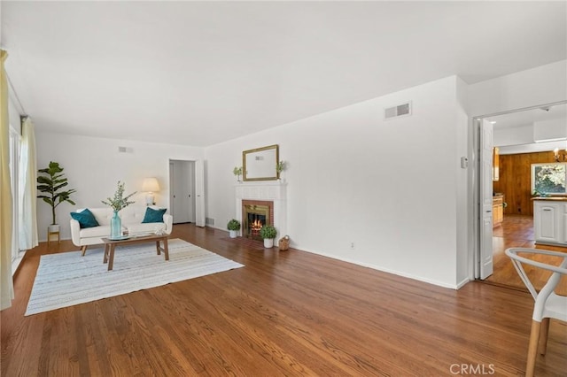 1424 E Vine Ave, West Covina, CA 91791 - sitting room with wood finished floors, a fireplace, and baseboards