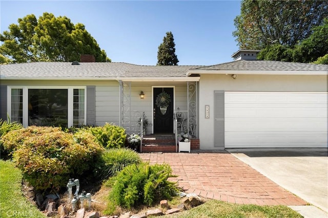 1424 E Vine Ave, West Covina, CA 91791 - ranch-style home with concrete driveway, a garage, a chimney, and roof with shingles