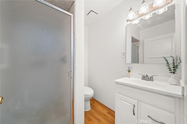 1424 E Vine Ave, West Covina, CA 91791 - bathroom with a shower stall, vanity, wood finished floors, and toilet