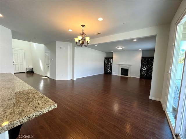 11407 Autumn Sage Ave, Jurupa Valley, CA 91752 - unfurnished living room featuring a chandelier, dark wood-type flooring, baseboards, recessed lighting, and a fireplace