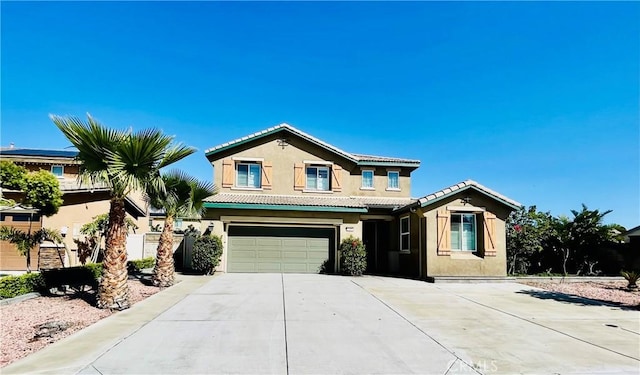 11407 Autumn Sage Ave, Jurupa Valley, CA 91752 - view of front of home with stucco siding, driveway, a garage, and a tiled roof