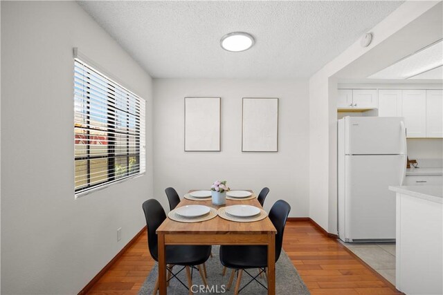1368 Elm Ave Unit B, San Gabriel, CA 91775 - dining area with a textured ceiling, light wood-style flooring, and baseboards