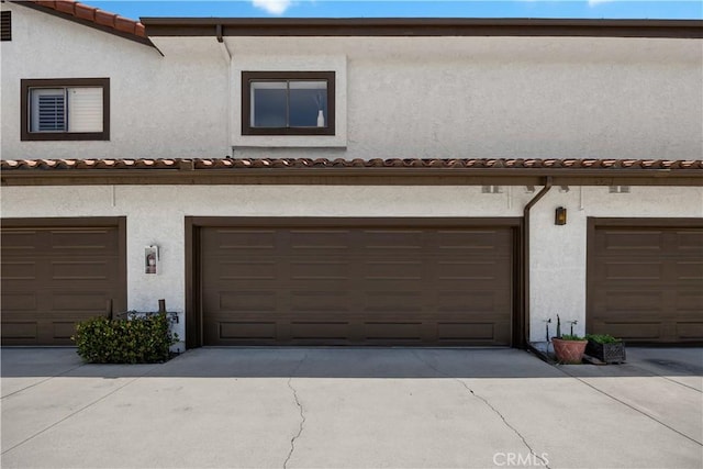 1368 Elm Ave Unit B, San Gabriel, CA 91775 - back of property with stucco siding, a garage, and a tiled roof