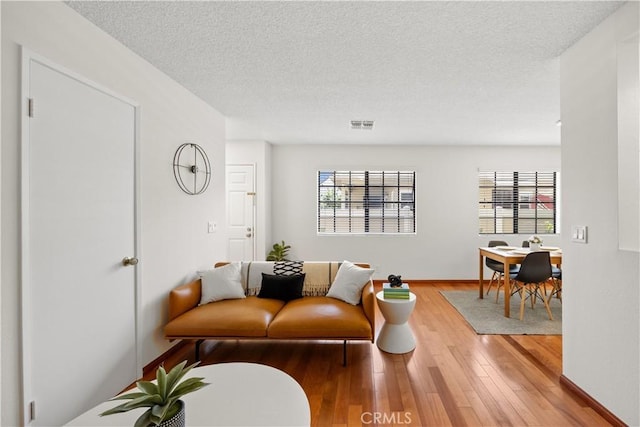 1368 Elm Ave Unit B, San Gabriel, CA 91775 - living area with plenty of natural light, hardwood / wood-style flooring, a textured ceiling, and baseboards