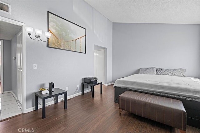 9158 Van Nuys Blvd Unit 8, Panorama City, CA 91402 - bedroom with wood finished floors, a textured ceiling, baseboards, and a chandelier