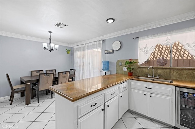 9158 Van Nuys Blvd Unit 8, Panorama City, CA 91402 - kitchen featuring beverage cooler, a sink, ornamental molding, a chandelier, and light tile patterned floors