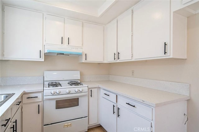 11408 Herb St Unit 7, South El Monte, CA 91733 - kitchen featuring white gas stove, under cabinet range hood, light countertops, and white cabinetry