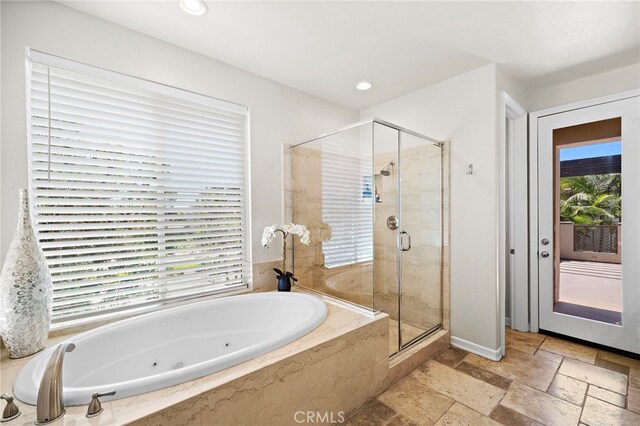 18976 Rockinghorse Ln, Huntington Beach, CA 92648 - bathroom featuring stone tile floors, a tub with jets, a stall shower, baseboards, and recessed lighting