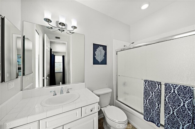 18976 Rockinghorse Ln, Huntington Beach, CA 92648 - bathroom featuring toilet, vanity, and shower / bath combination with glass door