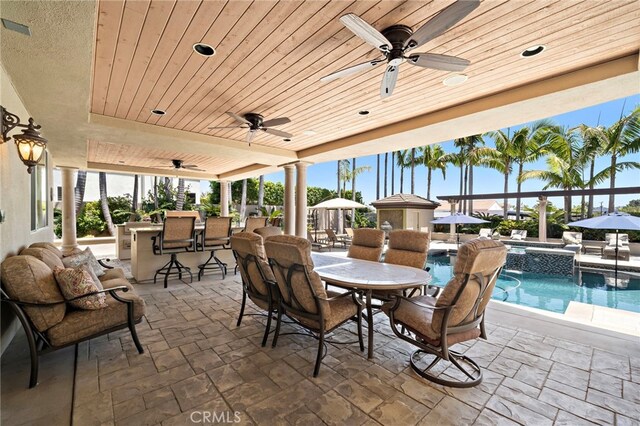 18976 Rockinghorse Ln, Huntington Beach, CA 92648 - view of patio / terrace with ceiling fan and a pool with connected hot tub