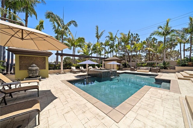 18976 Rockinghorse Ln, Huntington Beach, CA 92648 - view of swimming pool featuring a patio, an outdoor living space with a fireplace, and a pool with connected hot tub
