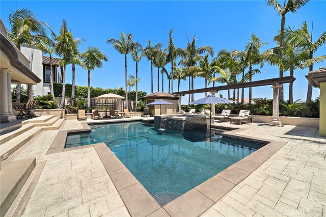 18976 Rockinghorse Ln, Huntington Beach, CA 92648 - view of swimming pool with a patio area and a pool with connected hot tub