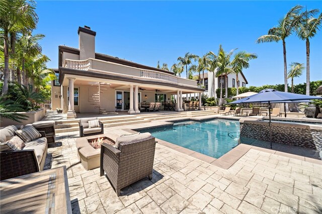 18976 Rockinghorse Ln, Huntington Beach, CA 92648 - view of pool with a patio, an outdoor living space with a fire pit, a pool with connected hot tub, and ceiling fan