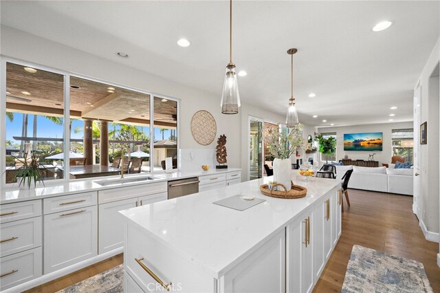 18976 Rockinghorse Ln, Huntington Beach, CA 92648 - kitchen with a sink, stainless steel dishwasher, recessed lighting, a center island, and white cabinets
