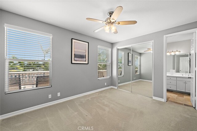 18976 Rockinghorse Ln, Huntington Beach, CA 92648 - unfurnished bedroom with light carpet, a closet, baseboards, and ensuite bathroom