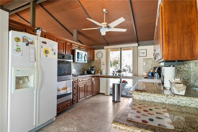 21166 E Rimpath Dr, Covina, CA 91724 - kitchen featuring stainless steel appliances, decorative backsplash, vaulted ceiling, a ceiling fan, and light tile patterned flooring